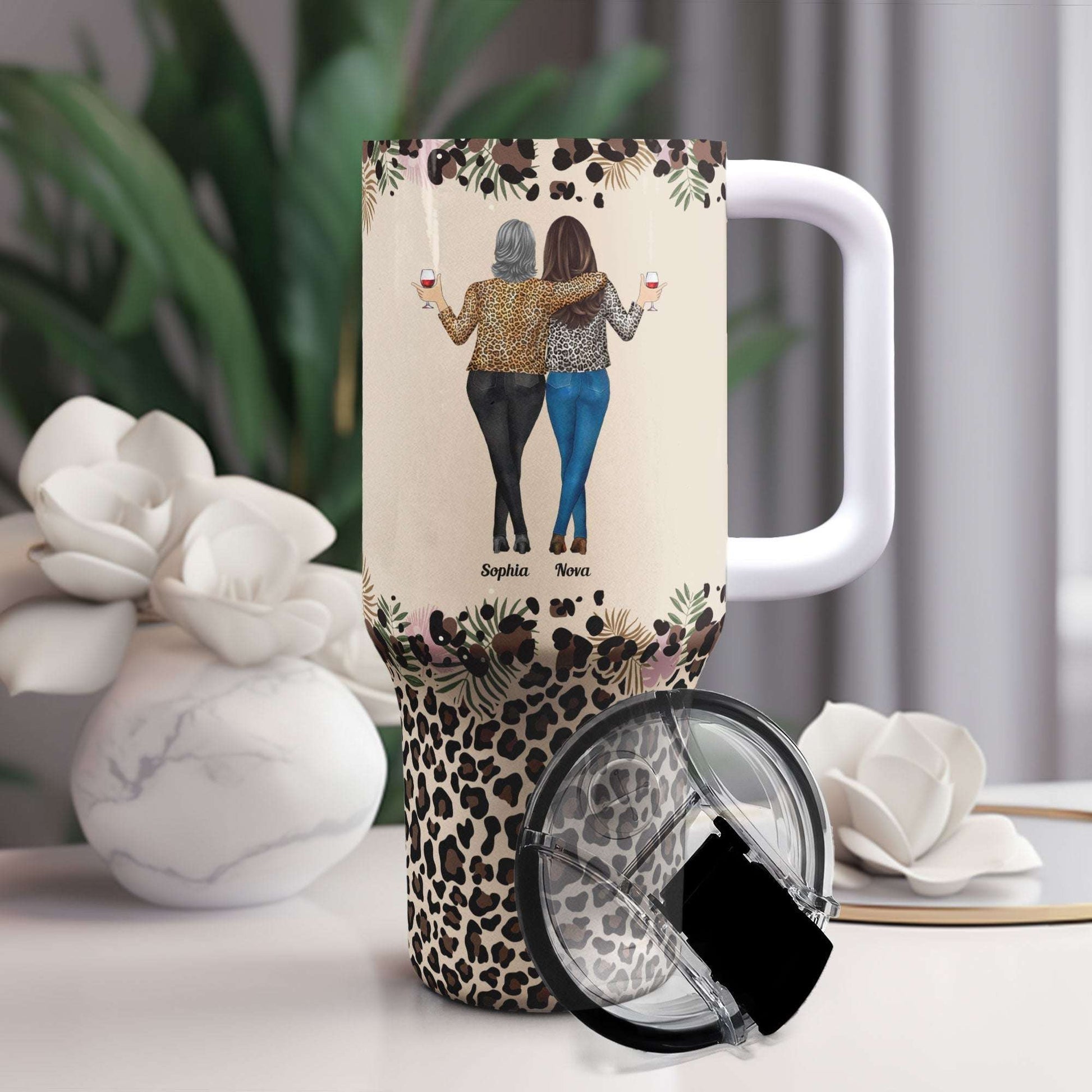 Personalized 40oz tumbler with straw, featuring "To My Badass Daughter" design and leopard print base, perfect gift.